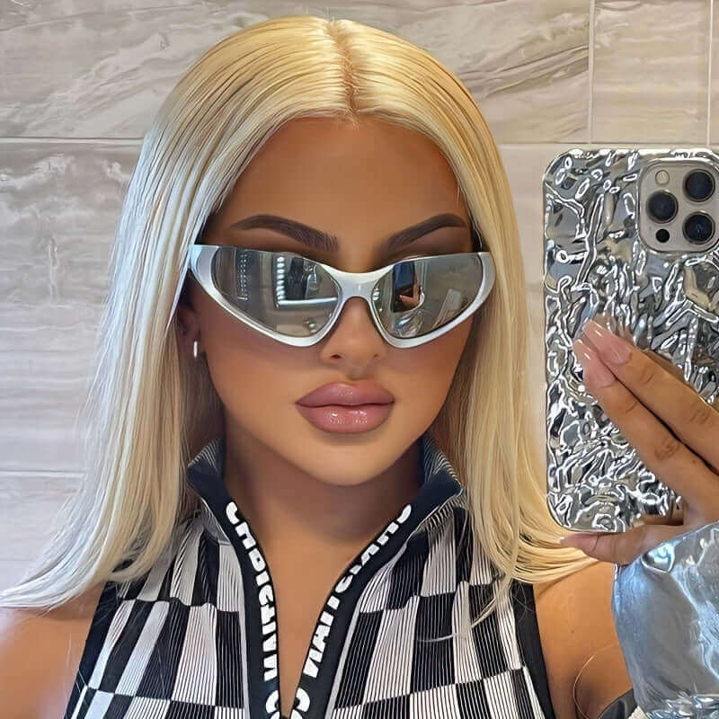 Woman wearing RaveFather Cyber Reflector Shield Sunglasses with bold futuristic style and reflective lenses, taking a selfie.