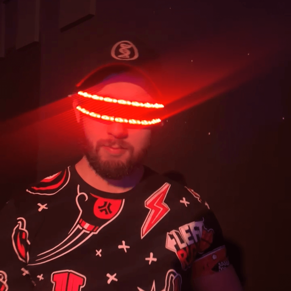 Man wearing RaveFather Celestial Harmony Rave Glasses with red LED light patterns at night.