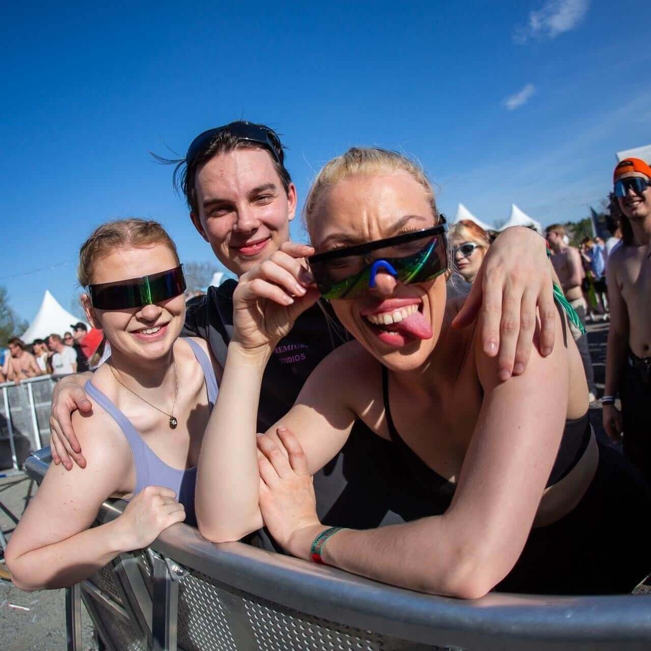 Group of people enjoying a festival while wearing RaveFather Vintage Sunglasses for stylish UV protection.