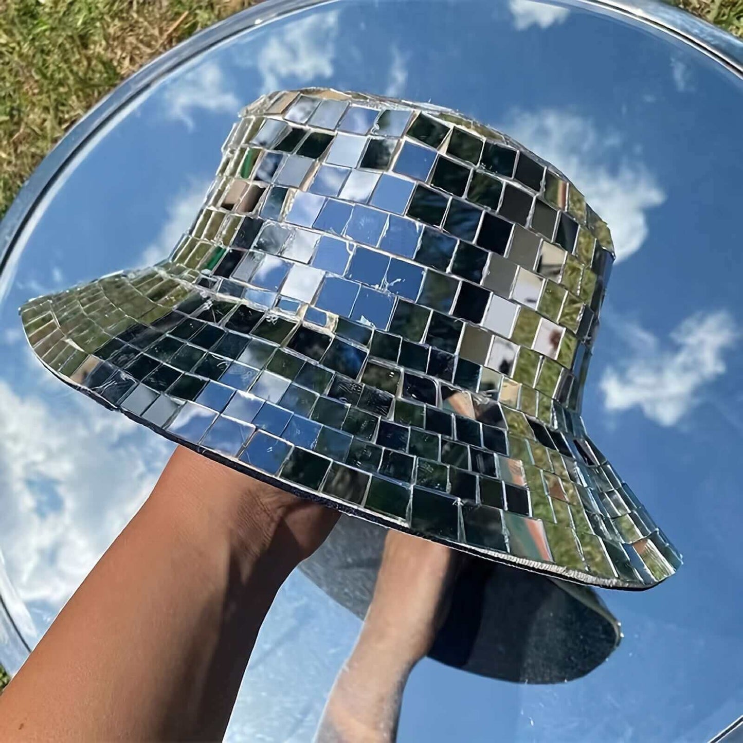 Reflective bucket hat with mirror tiles by RaveFather, ideal for festivals and parties, shown outdoors with sky reflection